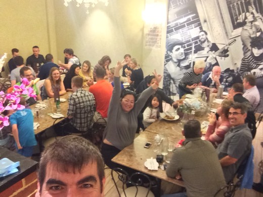 Gary taking a high-angle selfie over a full table of friends and supporters at the Hearts Across Australia pasta night