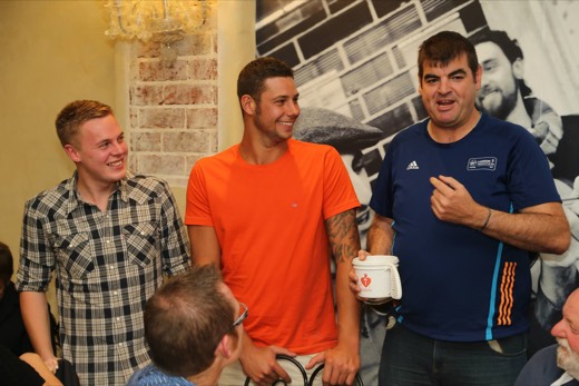 Gary standing with two supporters and a Heart Foundation collection tin during the pasta night