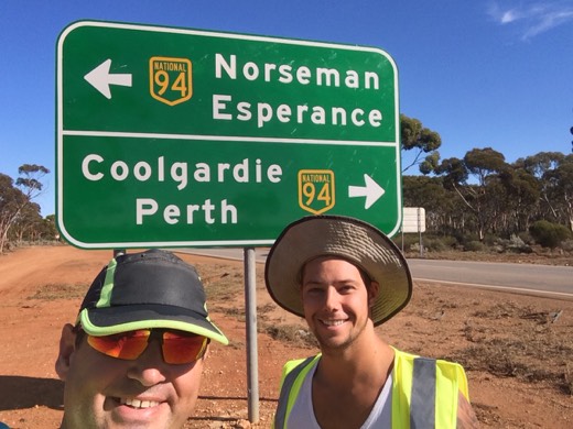 Gary and Ols beside a road sign pointing to Norseman Esperance Coolgardie and Perth