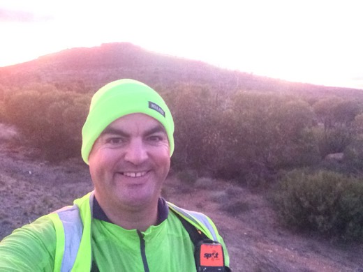 Gary smiling in high visibility gear at first light on the Eyre Highway