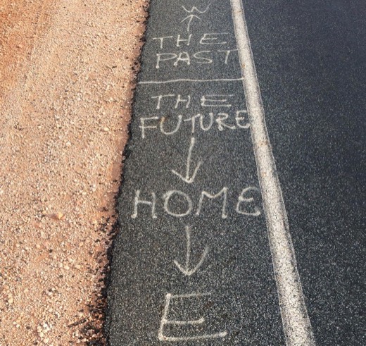 Roadside chalk arrows labelled past, future, and home