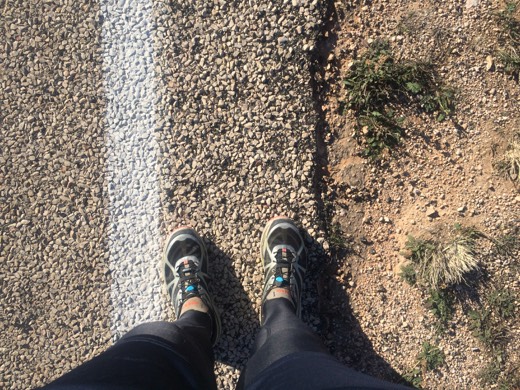 Gary's shoes beside the white edge line of the Eyre Highway