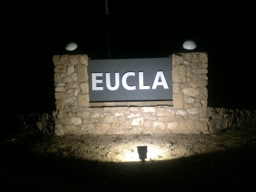 Eucla stone sign lit at night
