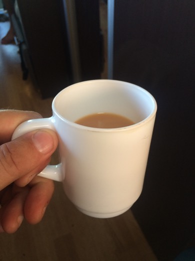 A mug of tea held inside the campervan near the Western Australia and South Australia border