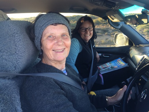 Rhonda and Cherre smiling from inside their car after stopping to check on Gary