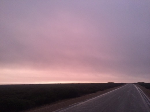 Heavy pink-grey cloud over the Eyre Highway and flat South Australian coastal plain