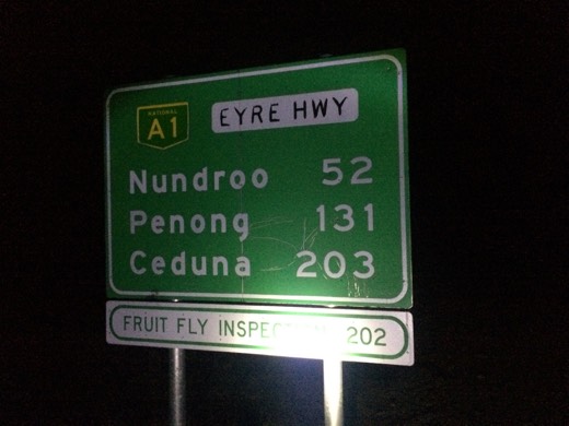 Eyre Highway sign in the dark showing Nundroo 52 kilometres away