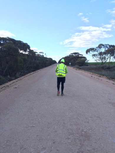 Gary walking along a quiet country road in hi-vis on Day 54