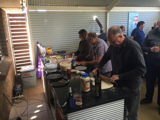 People preparing pizza during the McLaren Flat rest-day lunch