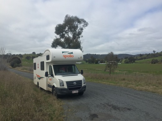 HAA campervan parked beside the Hume Highway in green New South Wales countryside.