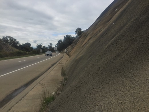 Hume Highway cutting with concrete walls and a narrow shoulder.