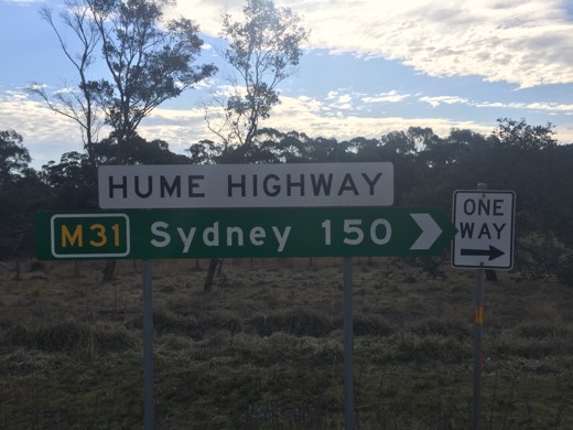 Hume Highway sign showing Sydney 150 kilometres away on Day 98.