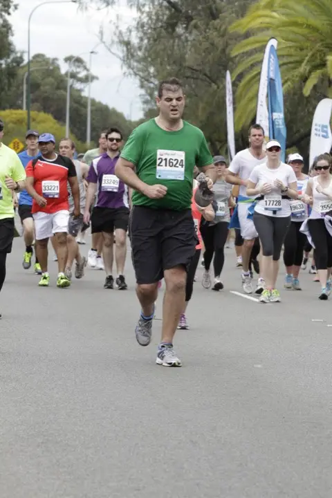 Gary running among a crowd during the 2013 Perth City to Surf event