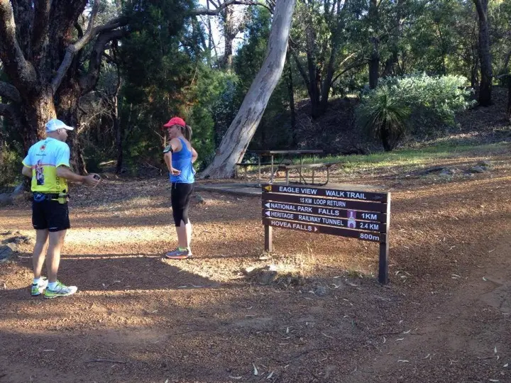 Pete Shinnick and Renee Notman standing near the Eagle View Walk Trail sign at John Forrest National Park